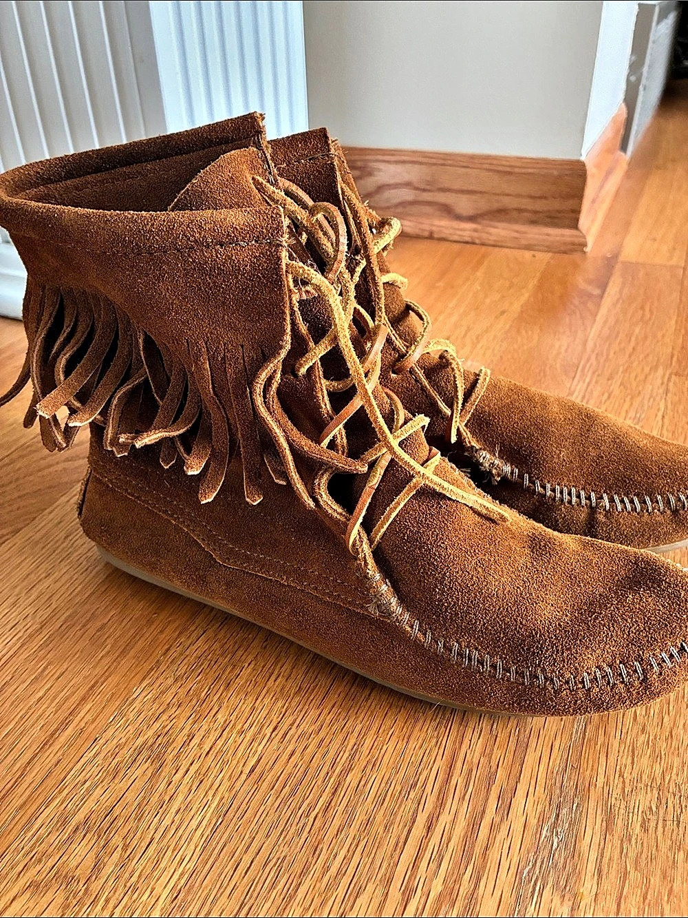Minnetonka fringe moccasin boots in Brown